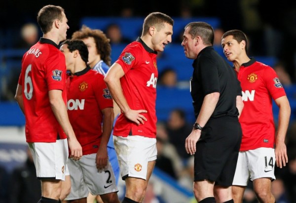 Manchester United's Vidic talks referee Dowd after being sent off during their English Premier League soccer match against Chelsea at Stamford Bridge